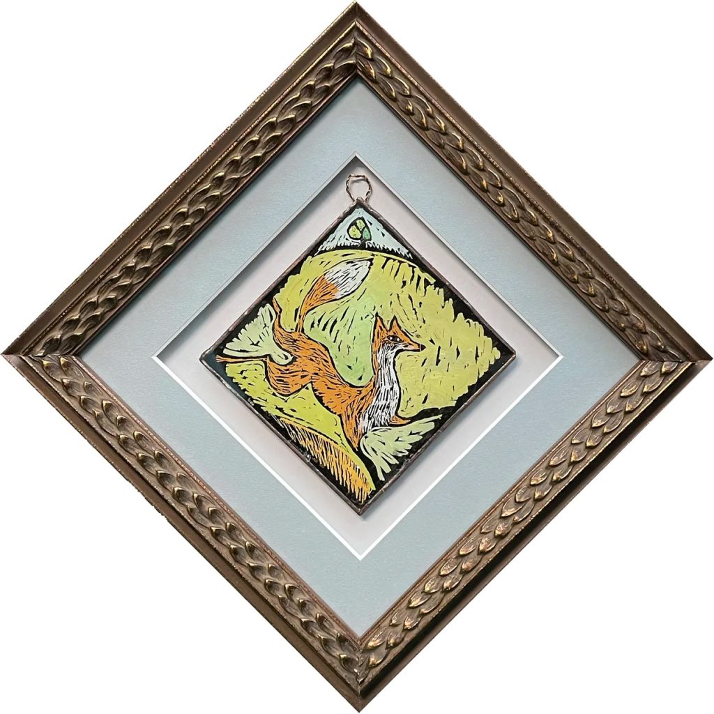 framed painted glass ornament depicting a running fox