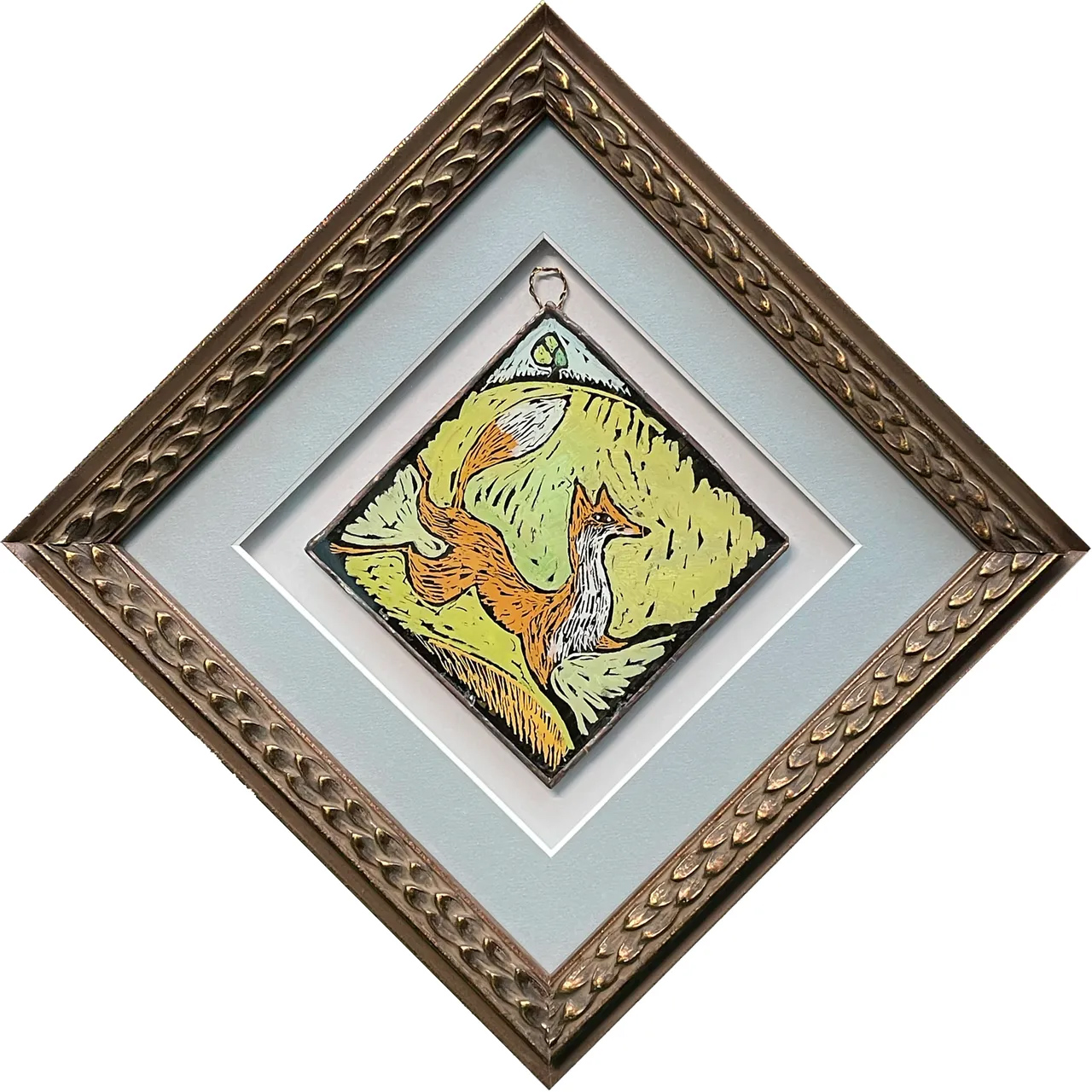 framed painted glass ornament depicting a running fox